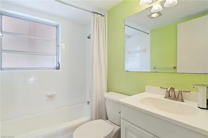 Full bath featuring shower / tub combo and vanity