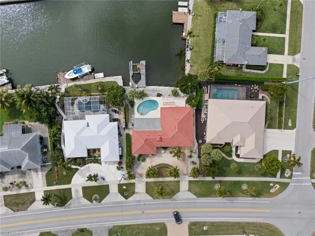 Aerial view of property's location featuring nearby suburban area and a large body of water