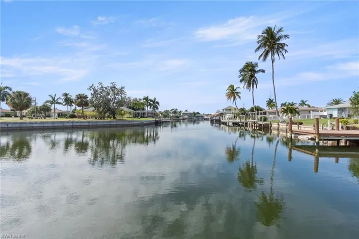 Water view with nearby suburban area and a dock