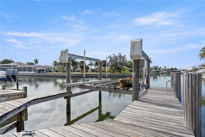 Dock area with boat lift and a water view