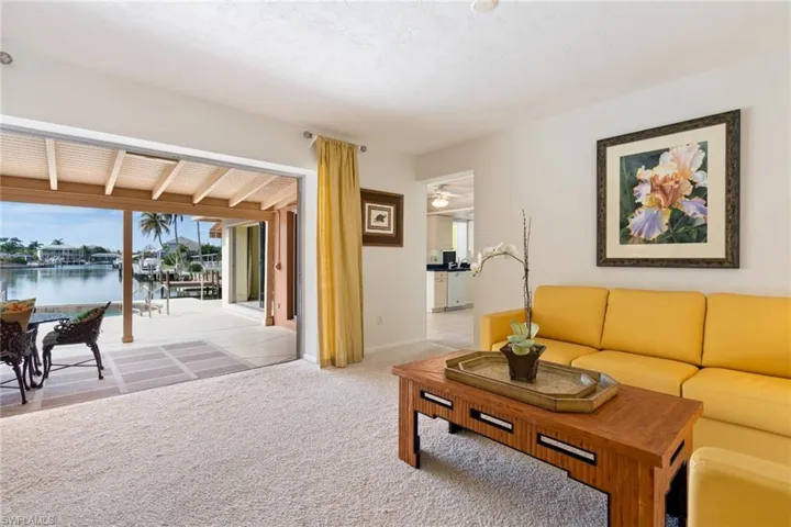 Carpeted living area featuring baseboards and a water view