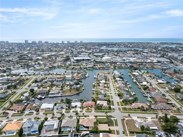 Aerial overview of property's location with a large body of water and nearby suburban area