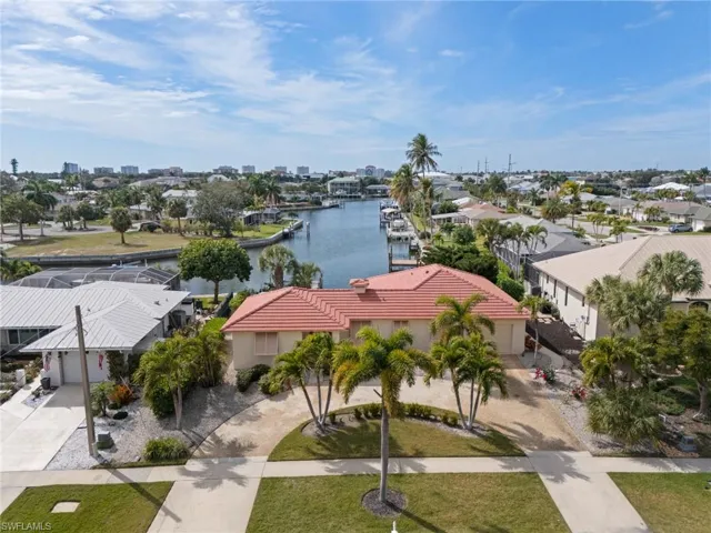 Aerial perspective of suburban area featuring a large body of water