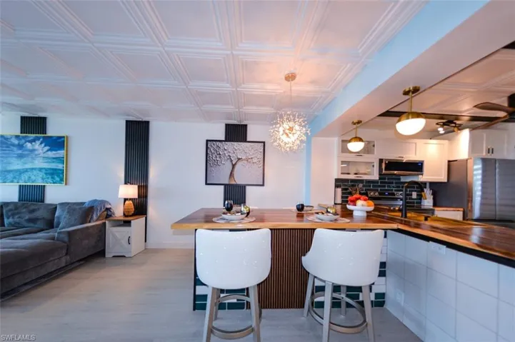 COUNTER-HEIGHT DINING EXTENSION W/TILE AND FLUTED WOOD ACCENTS