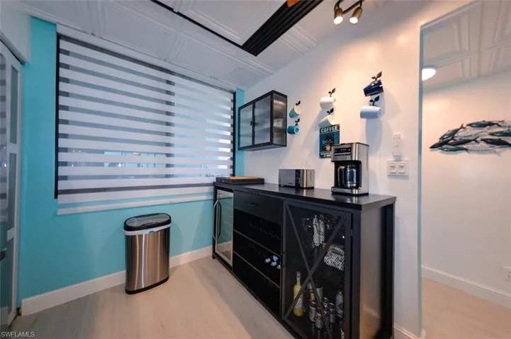 GLASS WALL-MOUNTED CABINET.  BUILT-IN BEVERAGE COOLER CABINET.  UNIT ENTRANCE IS TO RIGHT.
