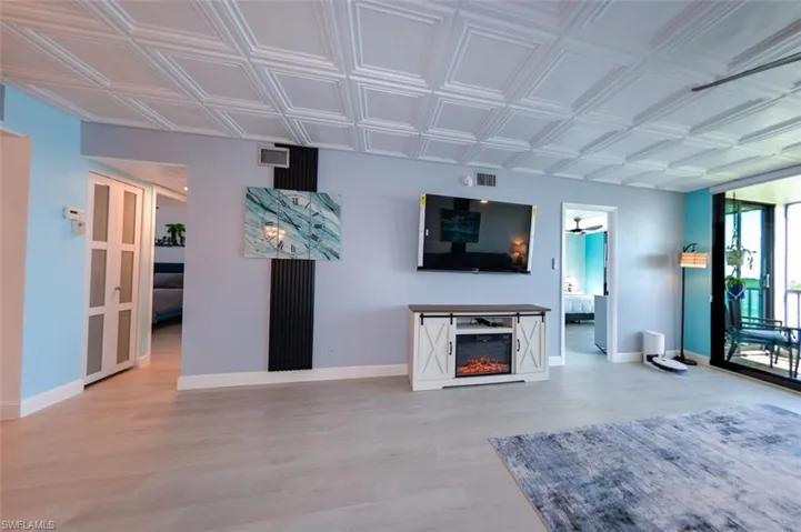 LIVING AREA SHOWING ENTRANCE TO GUEST BEDROOM, BATH AND LAUNDRY (LEFT).  ENTRANCE TO OWNER'S SUITE IS TO RIGHT.