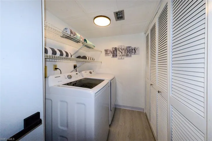 LAUNDRY ROOM.  SAMSUNG APPLIANCES.  STORAGE BEHIND LOUVERED DOORS.