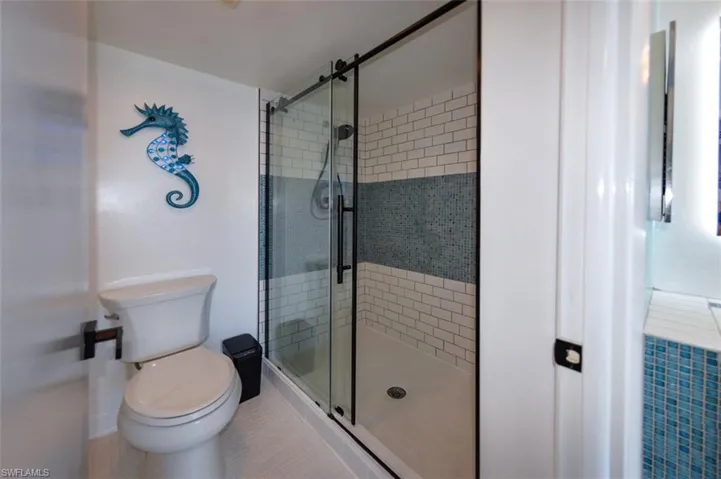 OWNER'S SUITE BATH.  FULLY TILED SHOWER W/TILE ACCENT.  FRAMELESS SHOWER DOORS.