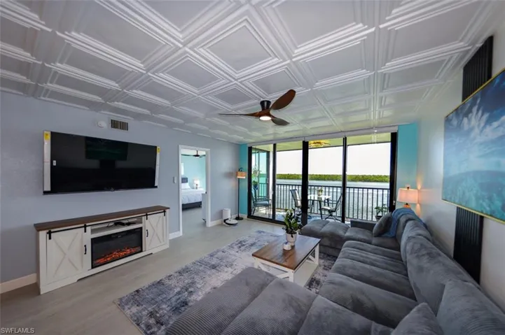 ELECTRONIC FIREPLACE W/STORAGE.  65" WALL-MOUNTED FLAT SCREEN TV.