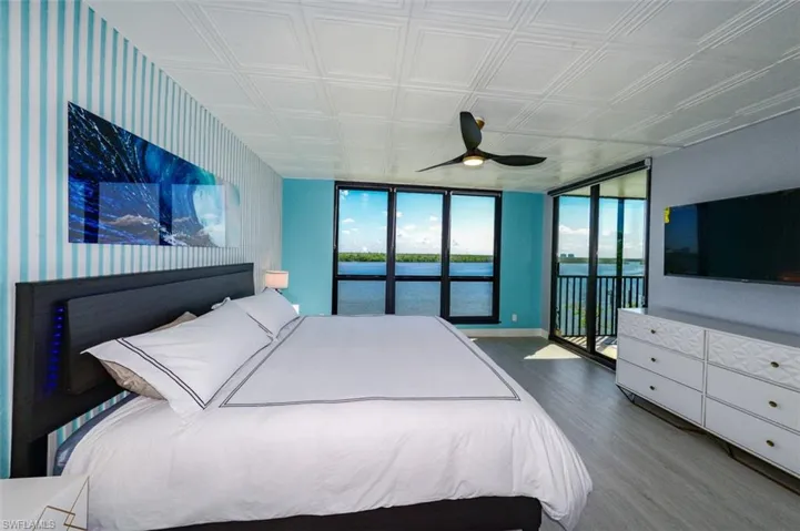 BED FRAME W/LED ACCENT LIGHTING.  WALL-MOUNTED FLAT SCREEN TV.  CUSTOM ZEBRA BLINDS.