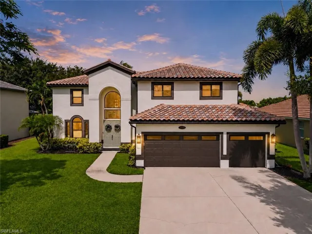 Mediterranean-style residence featuring a tile roof, stucco exterior, and a two-car garage