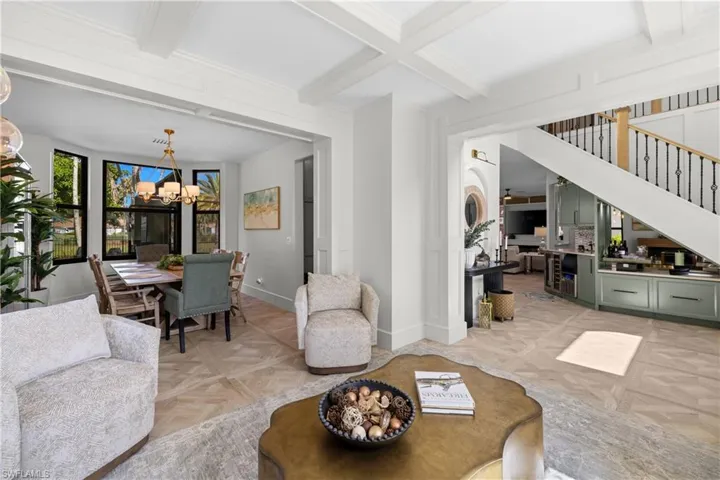 Coffered ceilings complement the wood-finish flooring in a chevron pattern