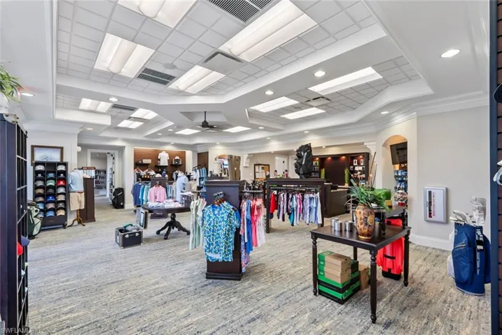 The property features a well-lit interior with recessed and panel lighting, crown molding, and a textured carpet