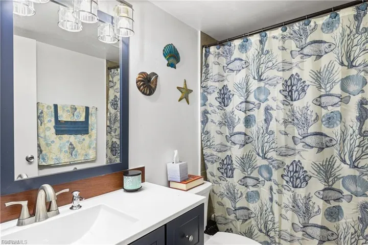 Full bath with vanity and curtained shower