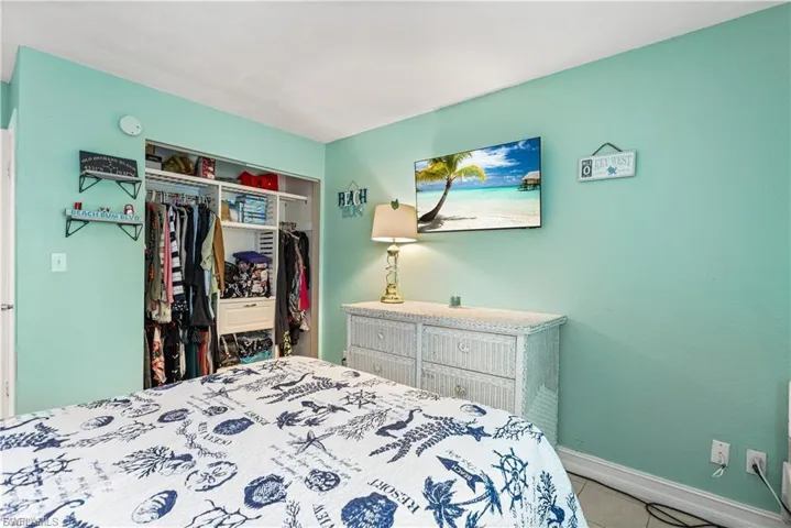Bedroom with tile patterned flooring and a closet