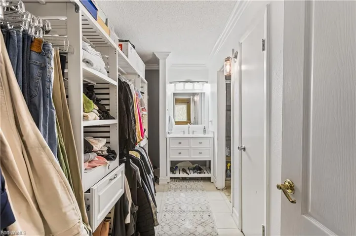 Walk in closet featuring light tile patterned flooring