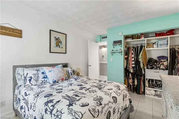 Bedroom featuring a closet and light tile patterned floors