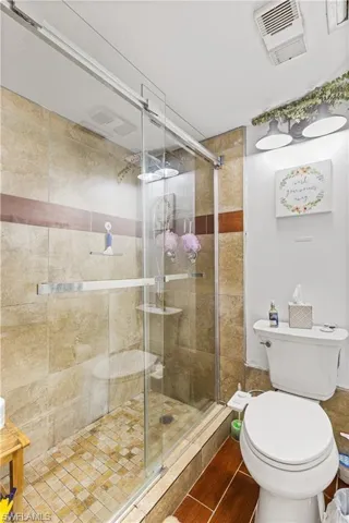 Bathroom featuring toilet and a shower stall