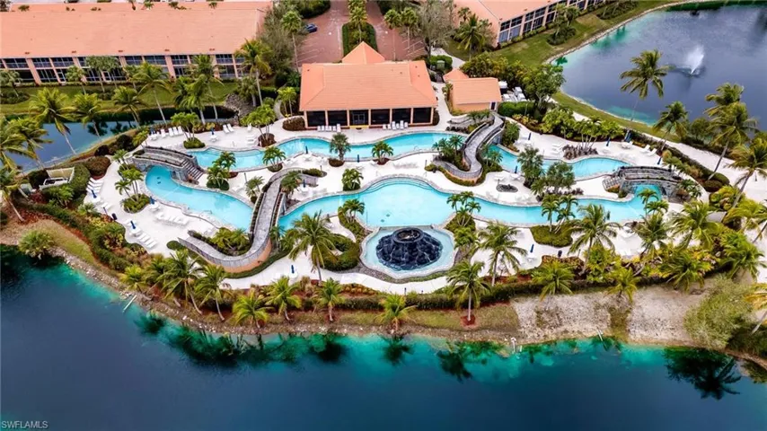 Aerial view of property's location with a large body of water and a pool area