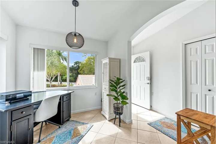 Office area featuring light tile patterned floors and baseboards
