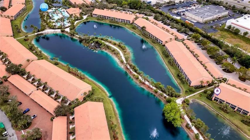 Bird's eye view of a nearby body of water and apartment complex / building