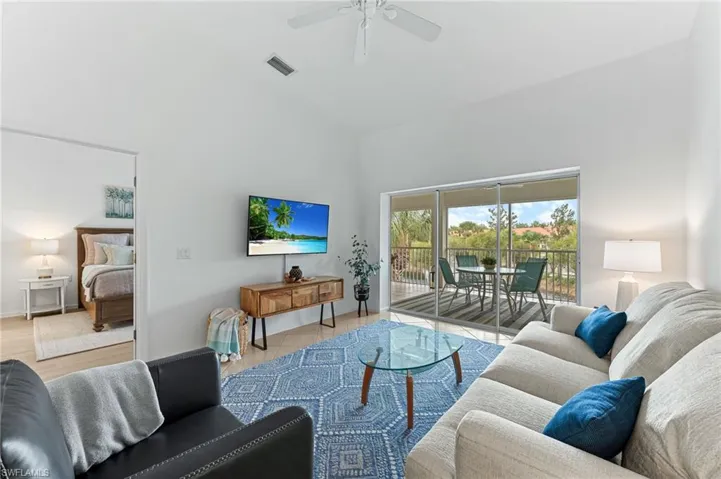 Living area featuring high vaulted ceiling and ceiling fan