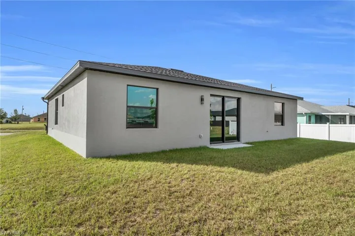 Back of property featuring stucco siding