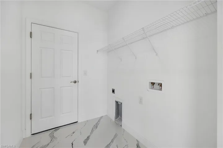 Laundry area featuring hookup for a washing machine, marble finish flooring, and electric dryer hookup