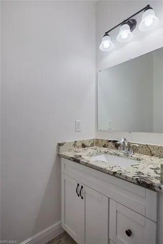 Bathroom featuring vanity and baseboards