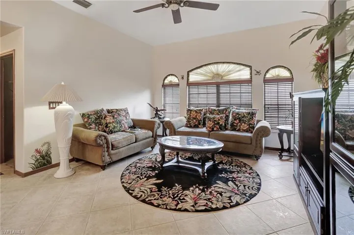 Living room featuring ceiling fan and light tile patterned flooring