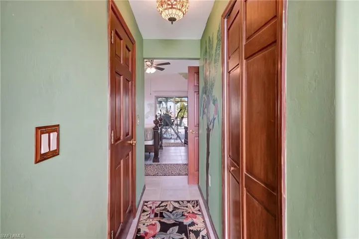 Hall featuring light tile patterned floors