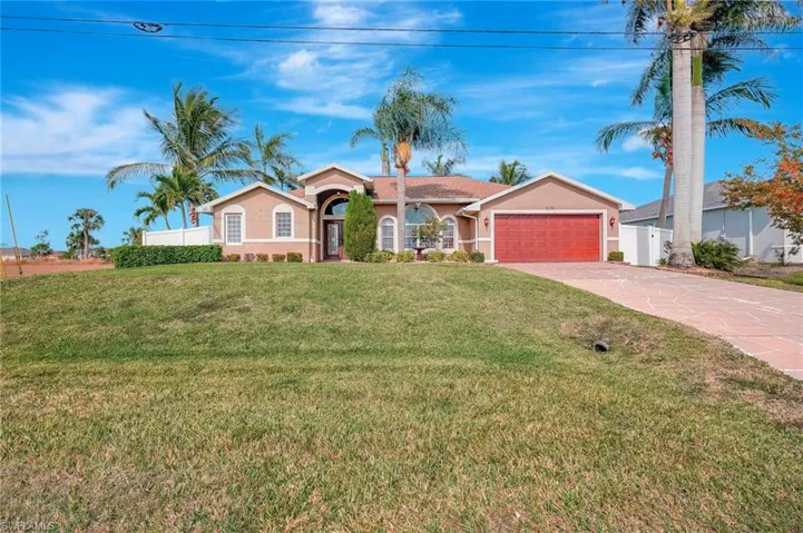 Single story home featuring a front lawn and a garage