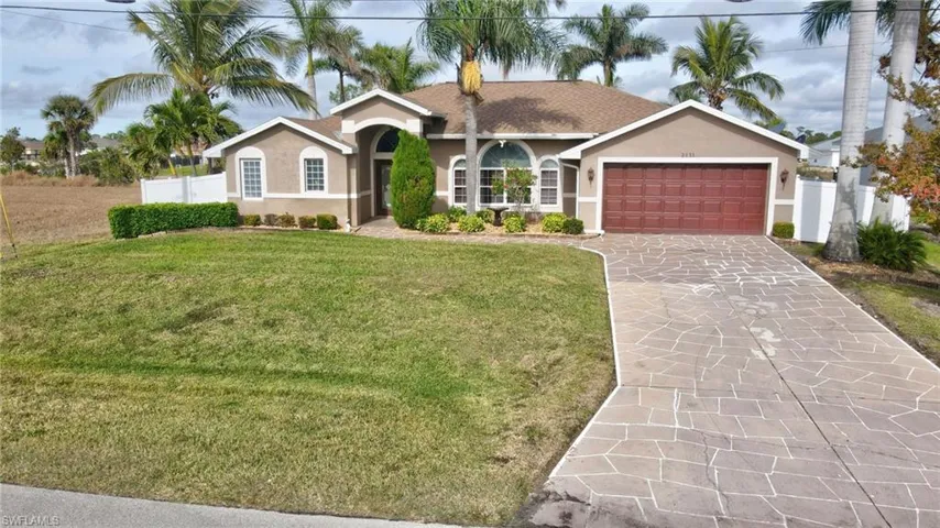 Single story home featuring a front lawn and a garage