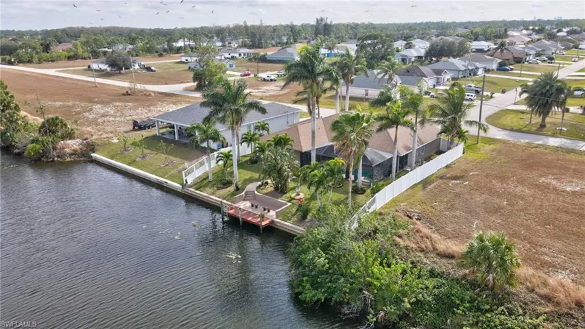 Birds eye view of property with a water view