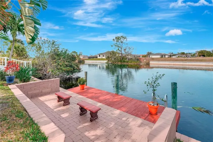 Dock area with a patio area and a water view