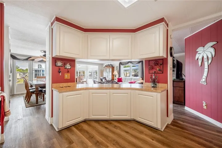 Kitchen featuring light countertops, wood finished floors, and baseboards