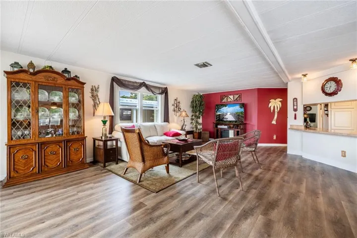 Living room featuring wood finished floors, baseboards, and visible vents