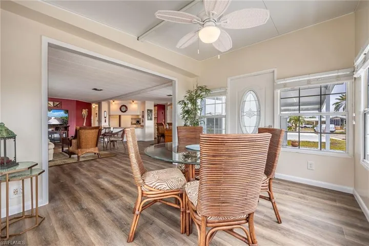 Dining space featuring plenty of natural light, baseboards, a ceiling fan, and wood finished floors