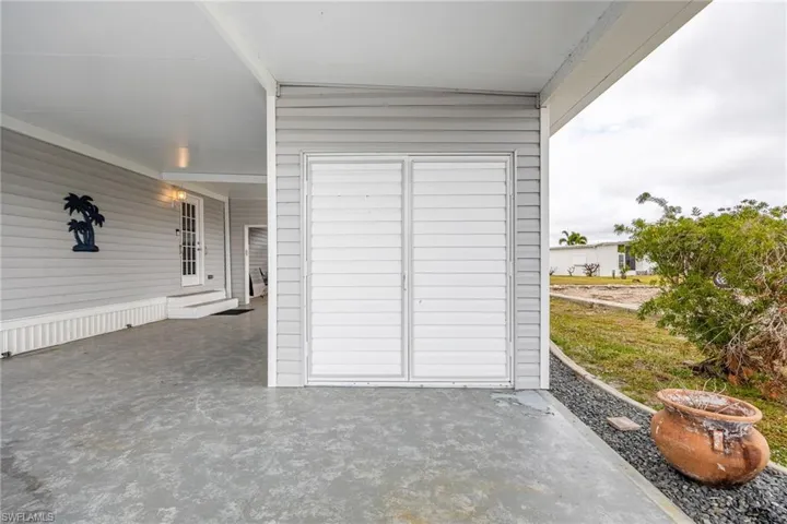 View of patio / terrace featuring entry steps and a carport