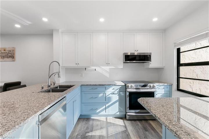 Appliances are also updated, including an induction stove and externally vented hood/microwave