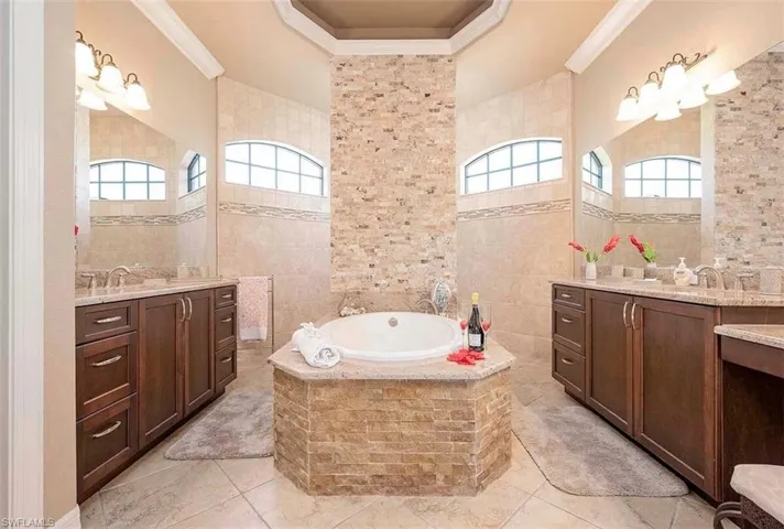 Primary Bathroom with walk through shower, dual sinks, separate tub and separate toilet
