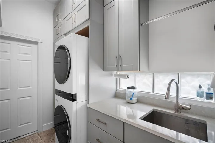 Laundry room with estacked washer and dryer and cabinet space