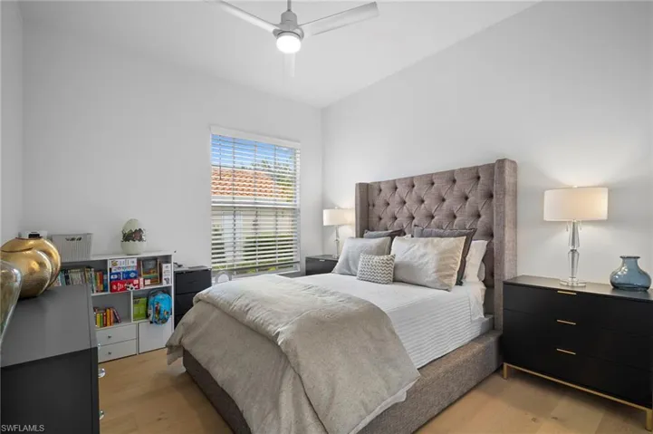 Bedroom with light wood finished floors and a ceiling fan