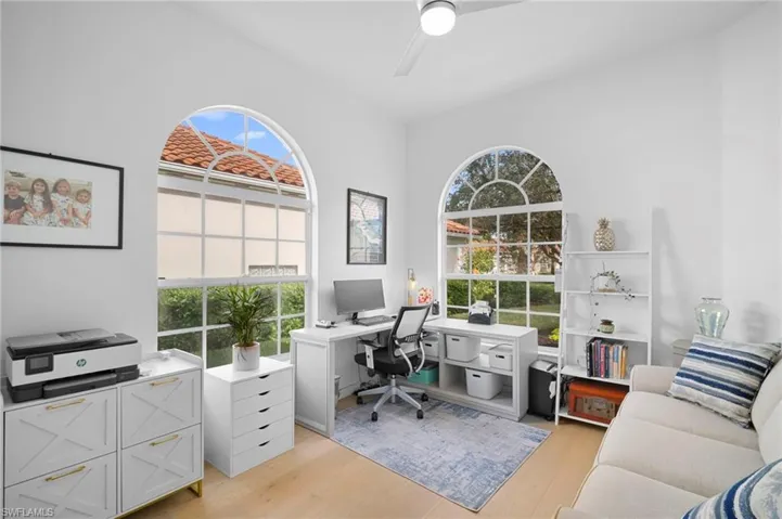 Office with light wood flooring and ceiling fan