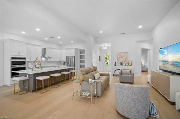 Living area featuring light wood flooring and recessed lighting
