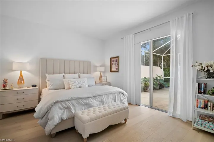 Bedroom with wood finished floors and access to outside