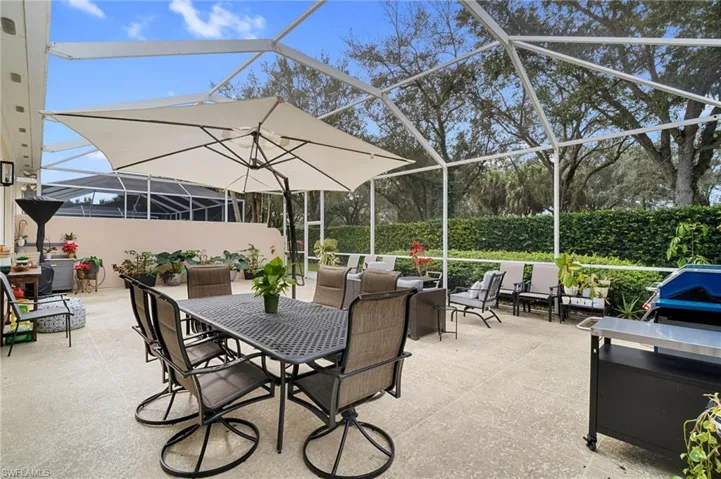 View of patio / terrace featuring a screen enclosure glass enclosure, outdoor dining area, and grilling area
