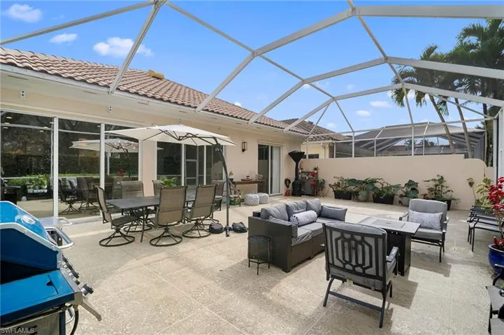 View of patio with screen enclosure, a sunroom, area for grilling, outdoor dining space, and an outdoor hangout area