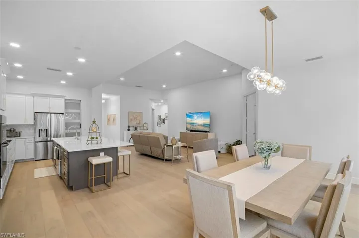 Dining room featuring light wood-style floors, recessed lighting, and a chandelier