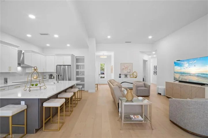 Living room featuring light wood floors and recessed lighting